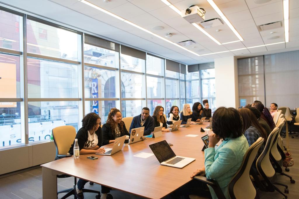 Boardroom with a group of office employees at a long table.