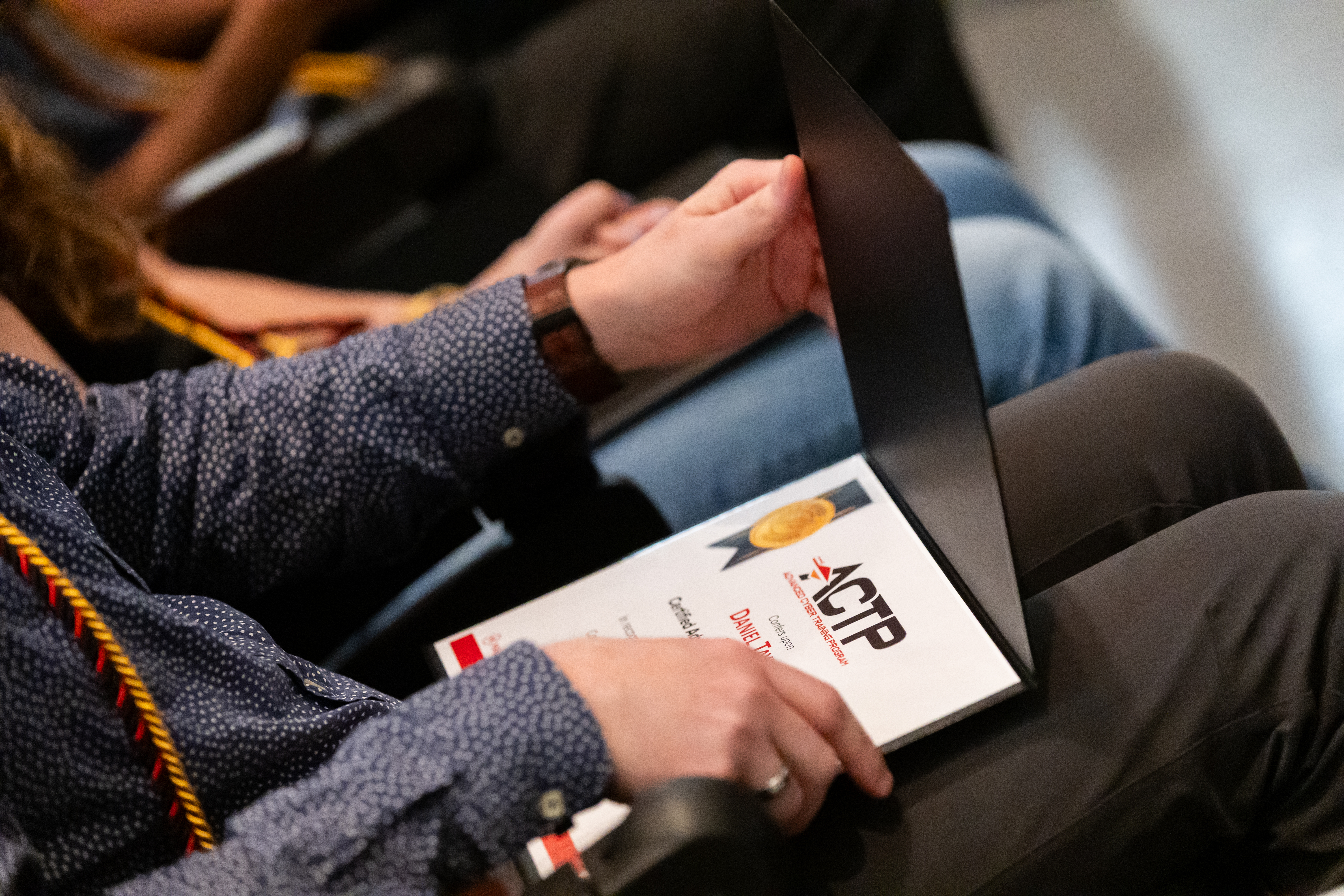 Person holding a tablet displaying a digital certificate